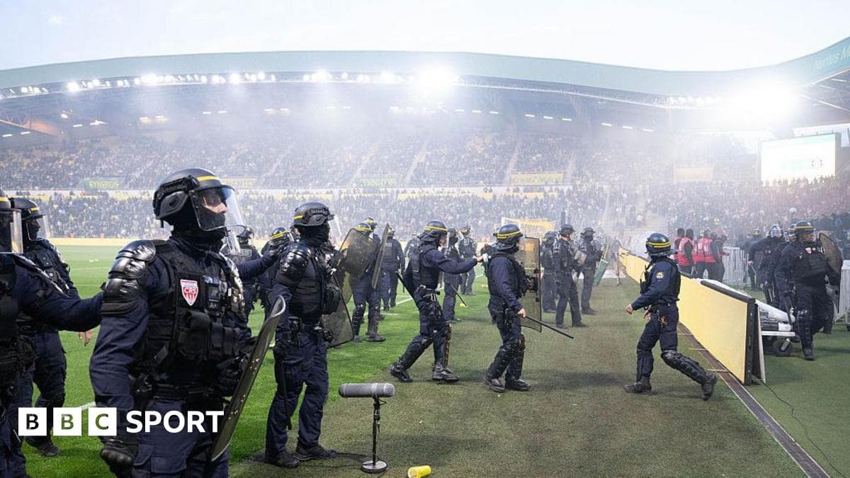 Ligue 1 game abandoned after fans invade pitch at relegated Nantes