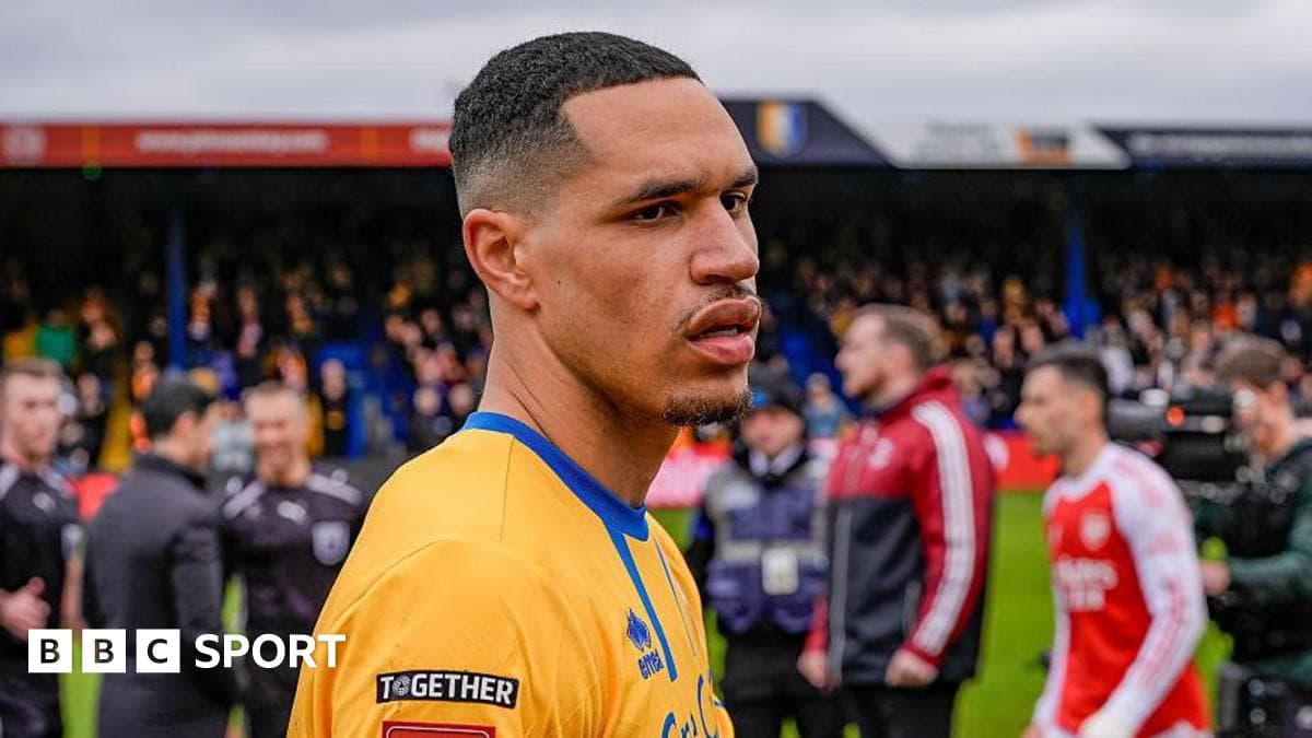 Mansfield sign midfielder Russell on two-year deal